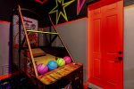 Challenge your family members to shoot hoops at the neon basketball arcade game